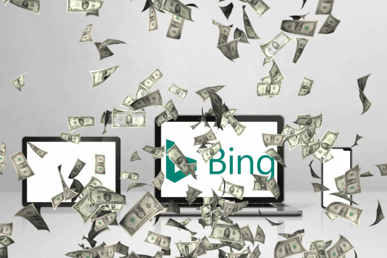 Notebook, tablet e celular exibindo o logo do Bing sob uma chuva de notas de dinheiro, ilustrando como ganhar dinheiro no Microsoft Rewards usando múltiplos dispositivos.
